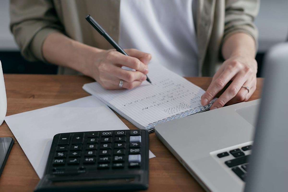 Woman, laptop and calculator